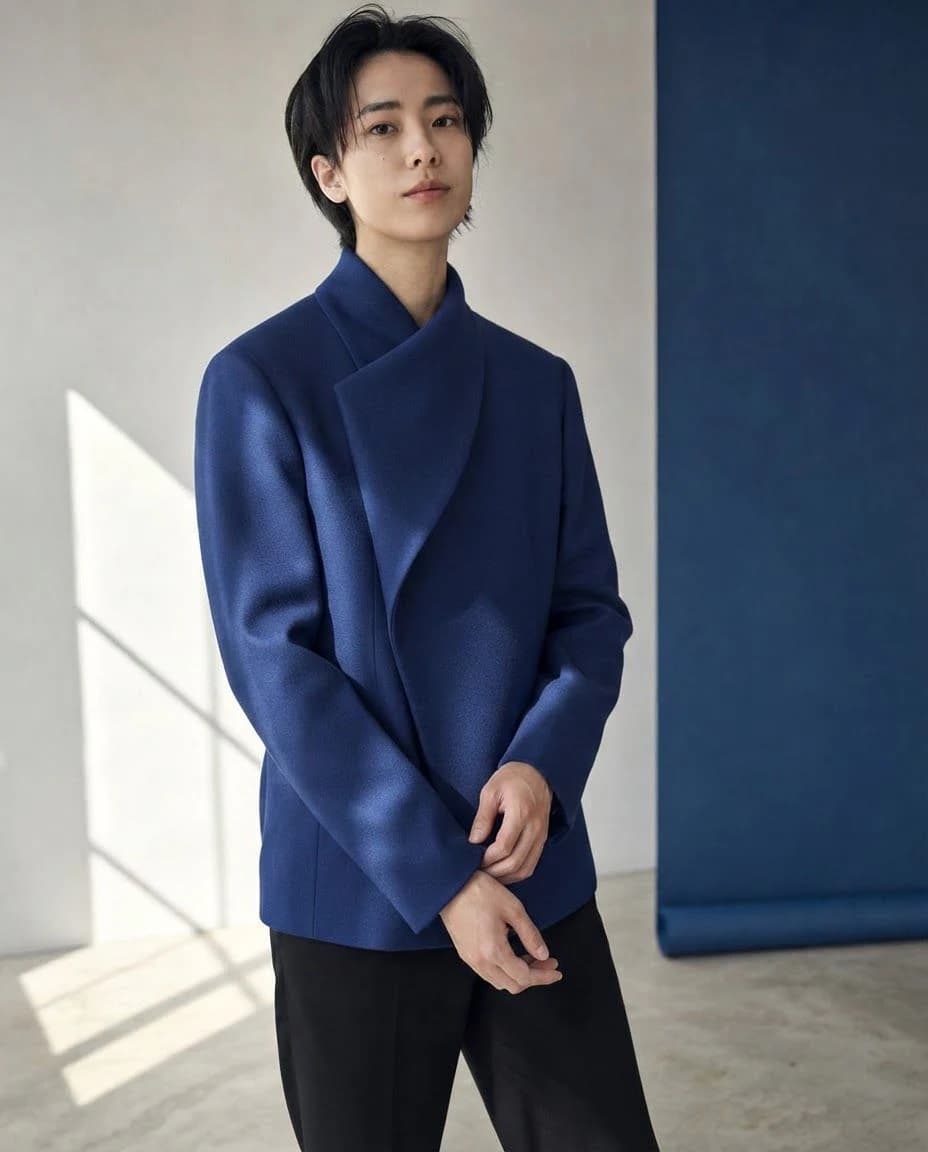 AI outfit result with a sculptural coat in an editorial studio frame
